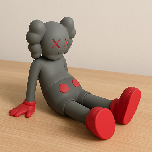 Gray and red toy figure with a minimalistic design on a wooden surface.